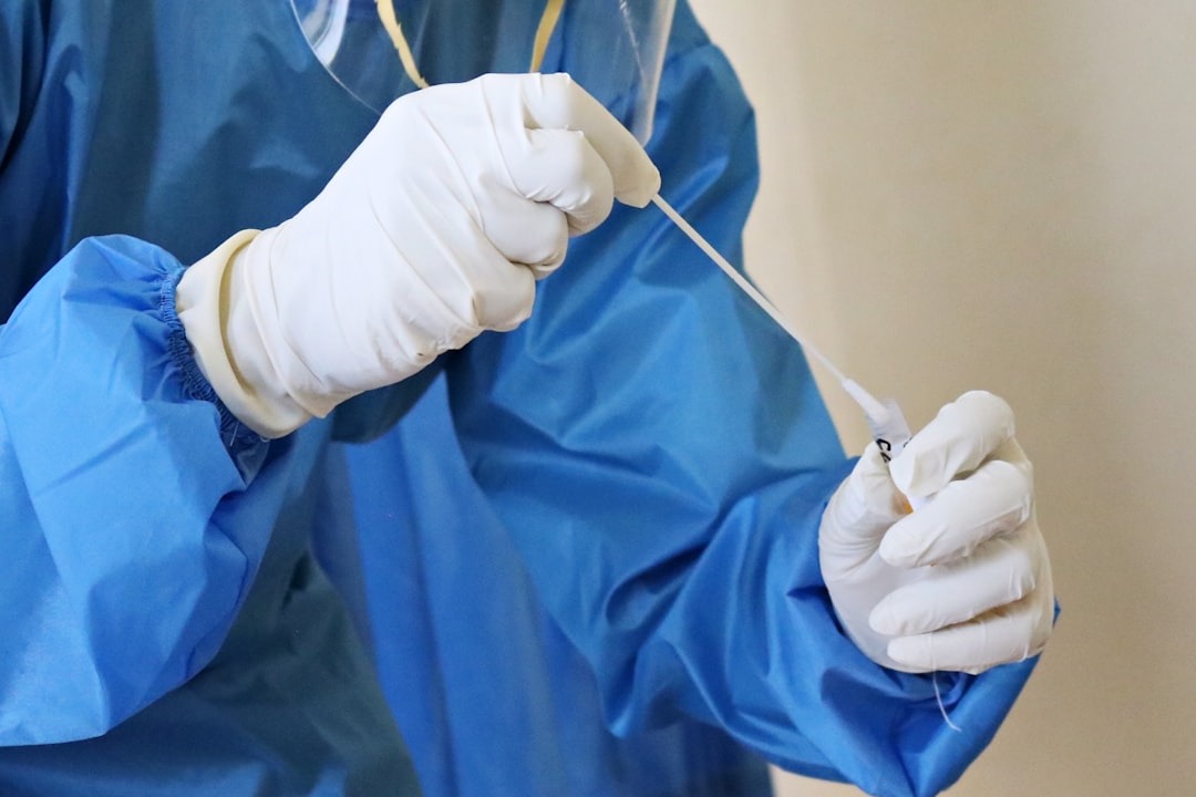 Medical professional prepares nasal swab for testing.