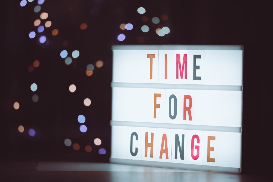 A light-up message board shows "TIME FOR CHANGE" with bokeh lights.